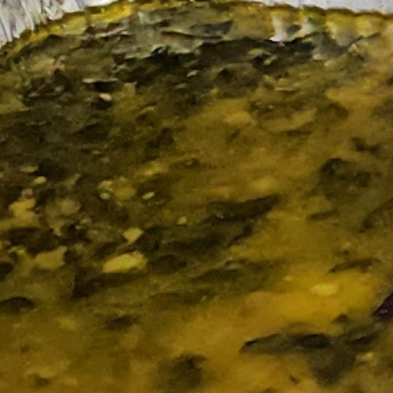 Close-up of a golden-brown, textured surface, possibly a baked good or casserole.